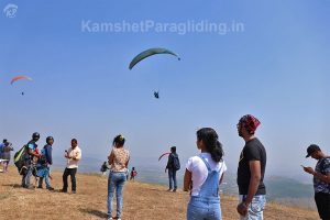 Tandem paragliding participants waiting for flight