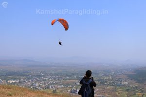 boy clicks photo of paragliding