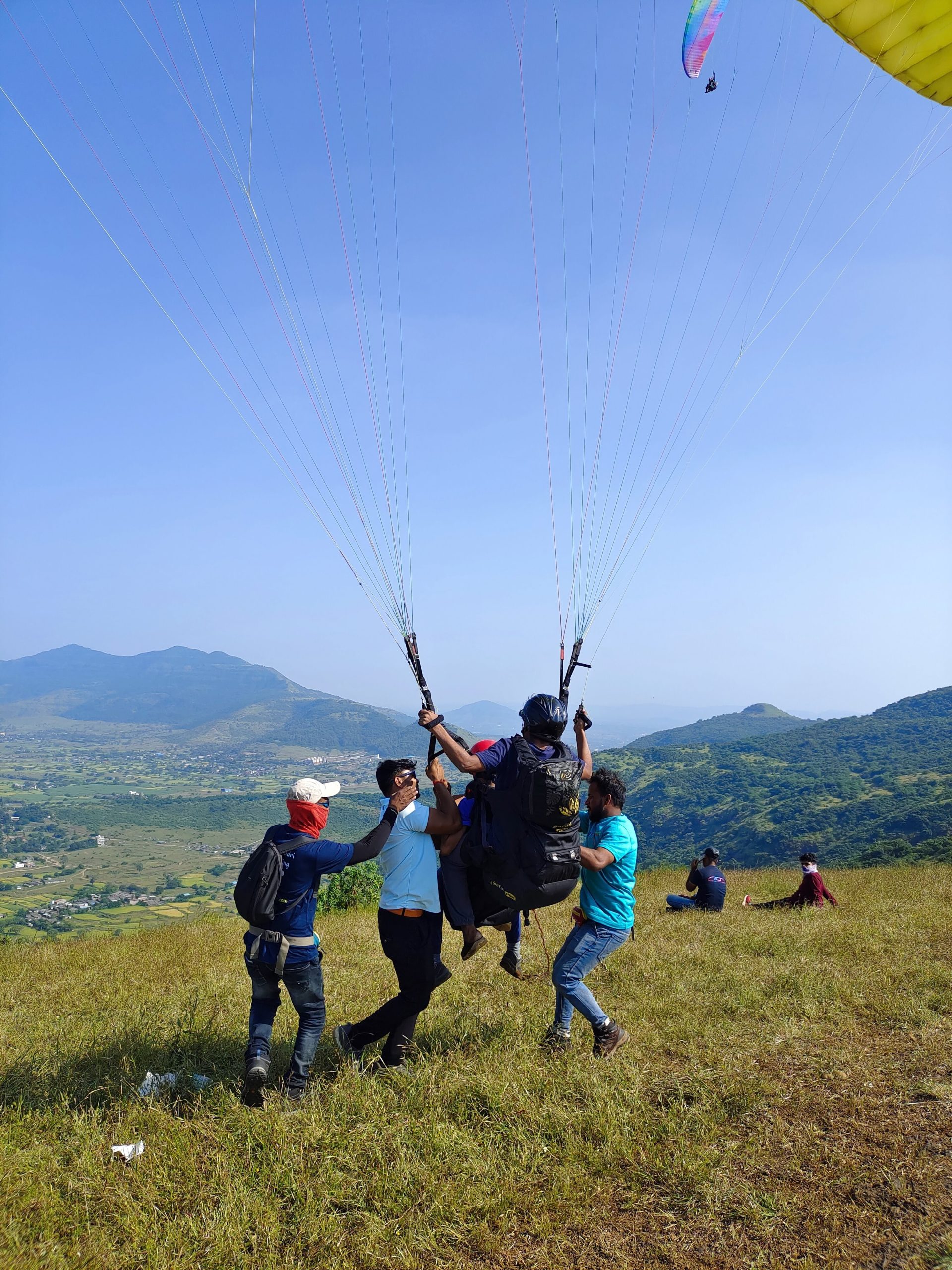 a group of people holding parachutes in the air